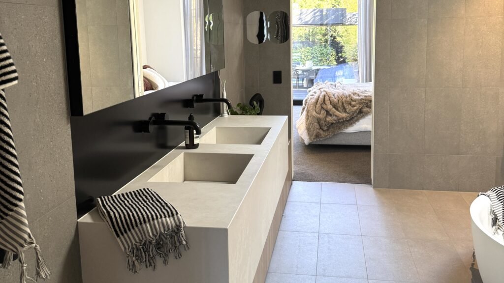 Modern bathroom interior with double vanity, minimalist fixtures, and neutral tones