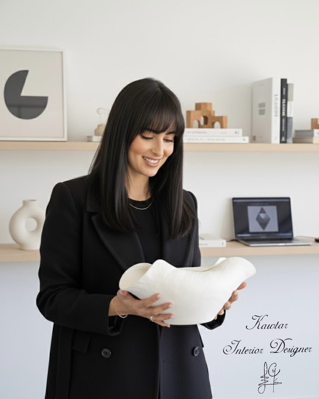 Interior designer reviewing sculptural decor in a modern studio space