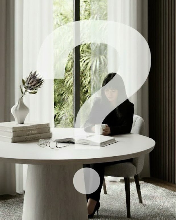 Interior designer working at a round table in a minimalist ODesign studio with natural light and modern decor